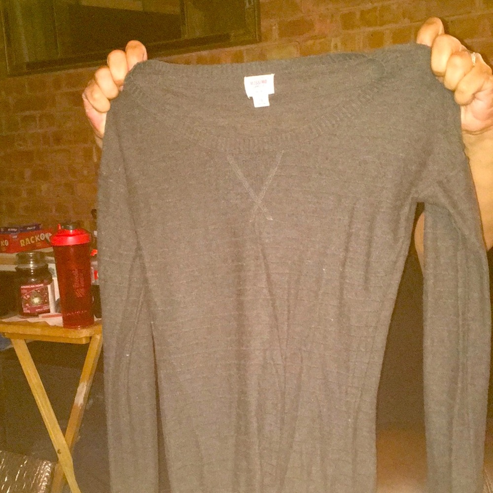 Long sleeved gray sweater.